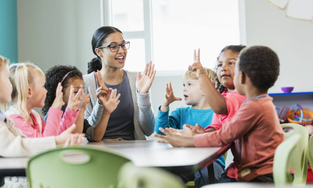 An educator, teaching a group of pre-school children